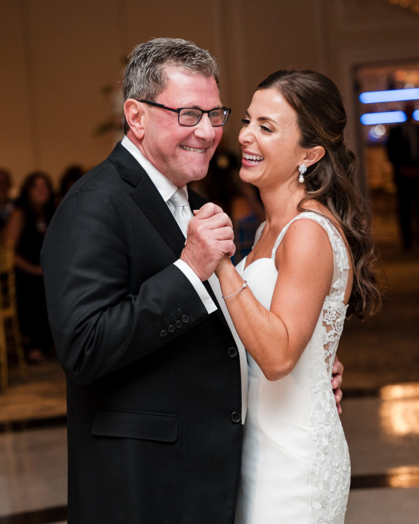 Bride dancing with her father. Captured by visual arts wedding photography