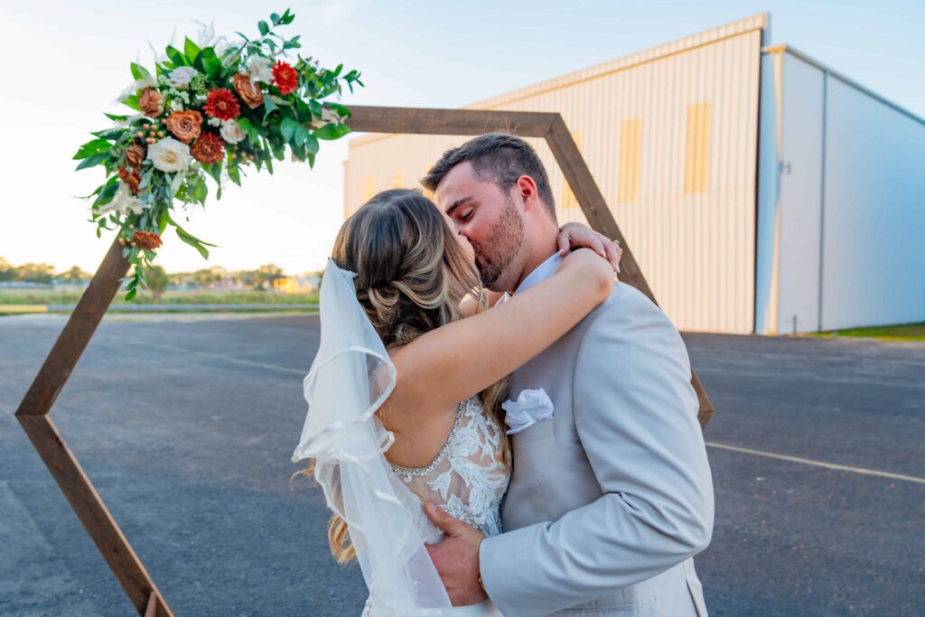 First kiss between the newlyweds airport hangar wedding in Sarasota. 