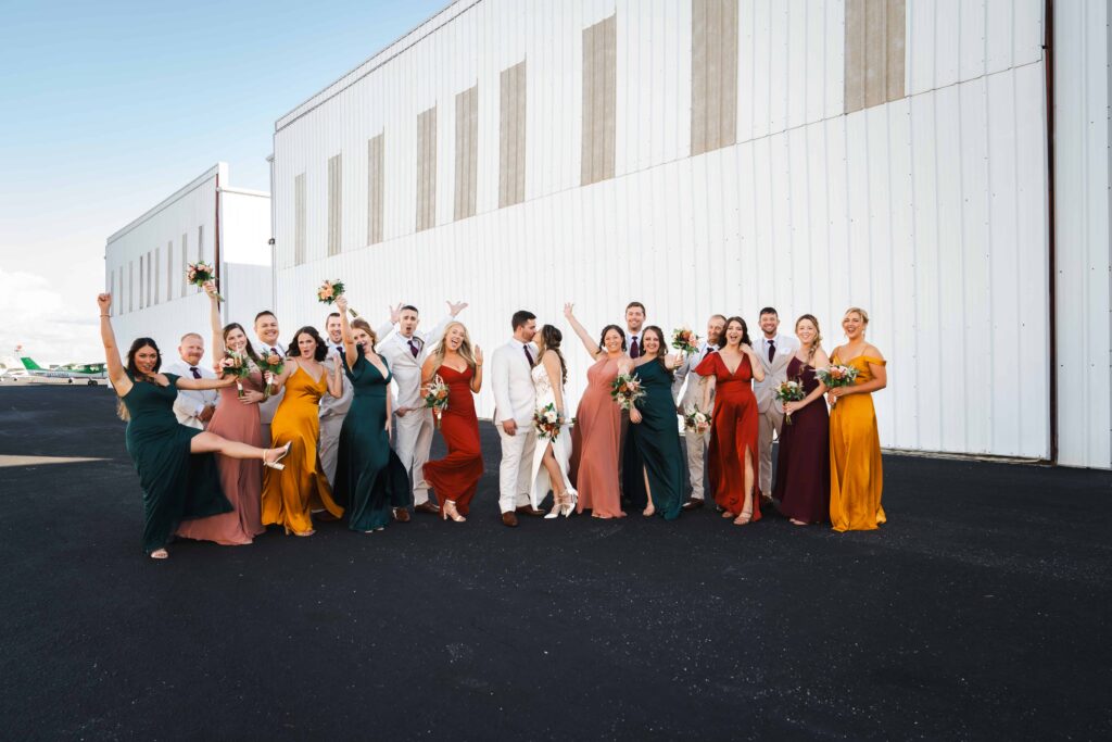 Sarasota Wedding Photographer - Visual Arts Wedding Photography- Image of the wedding party at airport hangar wedding in Sarasota.  